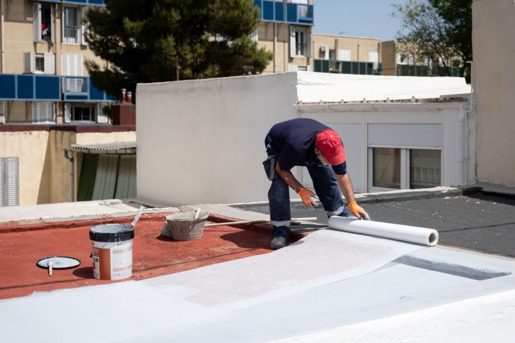 professional applying a roof coating